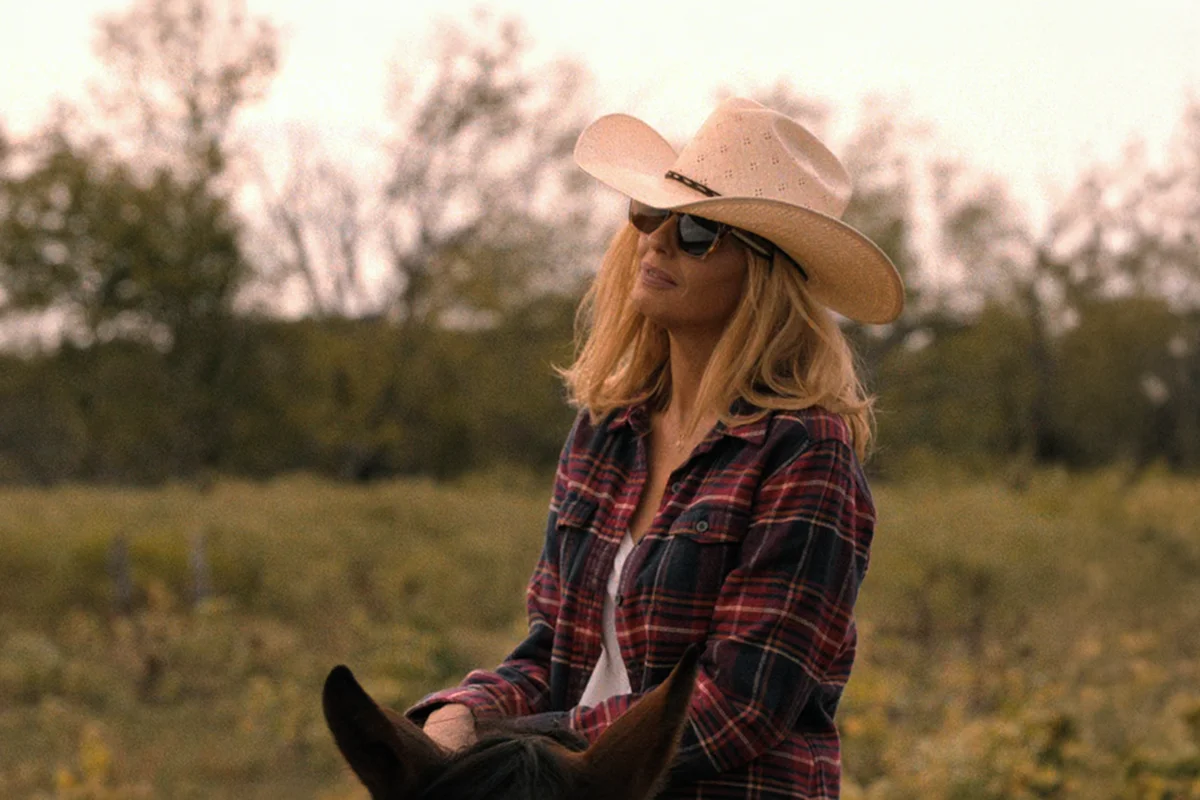 Beth's red flannel + light tan sunglasses on Dutton Ranch