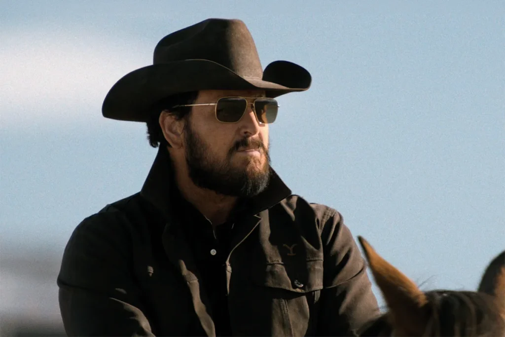 Rip's black Wrangler shirt + gold sunglasses on Dutton Ranch