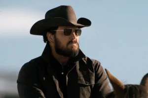 Rip's black Wrangler shirt + gold sunglasses on Dutton Ranch